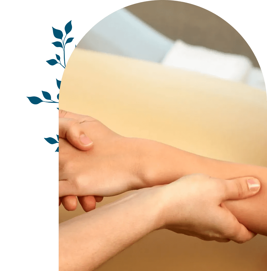Hands gently holding a foot, suggesting care or massage.